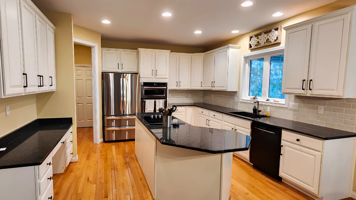 Bright completed kitchen with painted white cabinets